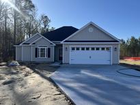 Newly constructed home with a two-car garage and neutral siding at 1033 Sioux Swamp Dr., Conway, SC 29527