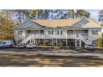 Tan colored multi-unit building with parking and landscaping at 160 Lazy Willow Ln. # 204, Myrtle Beach, SC 29588