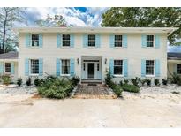 Brick house with light blue shutters, a brick walkway, and landscaping at 201 River Rd., Georgetown, SC 29440