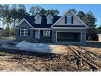 New construction home with stone and shingle exterior, two-car garage, and large windows at 2260 Pearl Rd., Galivants Ferry, SC 29544