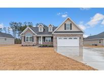 Charming single-Gathering home with a brick facade, dormer windows, and a well-manicured lawn at 2260 Pearl Rd., Galivants Ferry, SC 29544