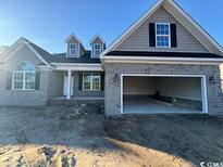 Two story home with gray brick and vinyl siding, large garage, and dormer windows at 2264 Pearl Rd., Galivants Ferry, SC 29544