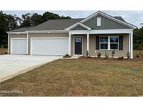 Newly built home with two-car garage and attractive landscaping at 364 Mayflower Dr., Calabash, NC 28467