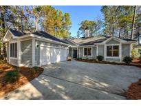 Gray house with two-car garage and nicely landscaped yard at 1237 Clipper Rd., North Myrtle Beach, SC 29582