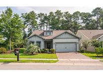 House exterior showing a charming craftsman style home with a two car garage and manicured lawn at 1926 Bluff Dr., Myrtle Beach, SC 29577