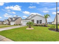 White house with landscaping, driveway, and palm trees at 2020 Santa Maria St., Myrtle Beach, SC 29579