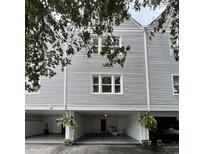 Three-story house with neutral siding and covered parking area with room for multiple vehicles at 414 27Th Ave. N # B, Myrtle Beach, SC 29577