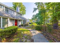 Gray house with red door and walkway, surrounded by green landscaping at 1203 Erin Way # B, Myrtle Beach, SC 29577