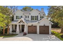 Stunning two-story white home with black shutters and a spacious two-car garage at 405 N Highland Way, Myrtle Beach, SC 29572