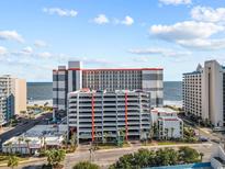 Coastal high-rise resort building with a multi-level parking deck and distant views of the ocean at 7200 Ocean Blvd. N # 254, Myrtle Beach, SC 29572