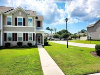 Charming home exterior with manicured lawn, sidewalk, and neutral siding at 516 Papyrus Circle # 516, Little River, SC 29566