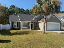 Charming single-story home with neutral siding, well-maintained lawn, and a two-car garage at 2549 Sugar Creek Ct., Myrtle Beach, SC 29579