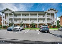 Inviting condo building with multiple balconies and parking spaces for residents and visitors at 3919 Gladiola Ct. # 304, Myrtle Beach, SC 29588