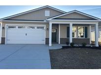 Charming single-story home with attached two-car garage and covered entry at 569 Beckham Ct., Murrells Inlet, SC 29576