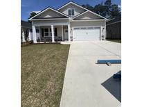 Charming single-Gathering home with a two-car garage, well-maintained lawn, and manicured landscaping at 582 Beckham Ct., Murrells Inlet, SC 29576