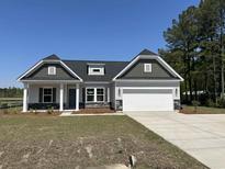 Charming single-Gathering home with a two-car garage, and landscaped front yard at 2275 King Farm Rd., Aynor, SC 29511