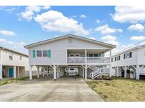 Charming raised beach house with covered parking and inviting porch at 404 32Nd Ave. N, North Myrtle Beach, SC 29582