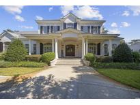 Stunning two-story white brick home with large columns and professionally landscaped front yard at 9318 Cove Dr., Myrtle Beach, SC 29572
