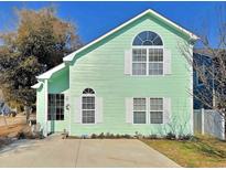 Charming two-story home with light green siding, white trim, and manicured front yard, creating a welcoming curb appeal at 829 9Th Ave. S, North Myrtle Beach, SC 29582