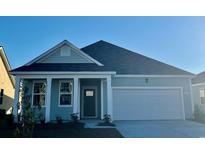 Charming single-Gathering home with a two-car garage and inviting light blue exterior at 567 Duvall St., Longs, SC 29568