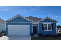 Charming blue single-Gathering home with a one-car garage and a well-manicured lawn under a bright blue sky at 573 Duvall St., Longs, SC 29568