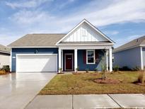 Charming blue single-story home with a well-manicured lawn and attached garage, perfect for suburban living at 576 Duvall St., Longs, SC 29568