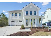 Two-story light gray house with white accents, double garage, and front porch at 1035 Milford Way, Myrtle Beach, SC 29588