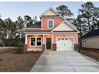 Charming two-story home with a two car garage, stone accents, a brown roof and a well-manicured lawn at 3131 Tiger Tail Rd., Conway, SC 29526