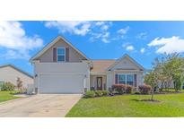 Charming single-Gathering home with a well-manicured lawn, attached garage, and neutral colored siding at 3412 Holly Loop, Conway, SC 29527