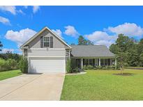 Charming single-story home with a well-manicured lawn and two-car garage at 2000 Easy St., Conway, SC 29526