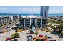 A picturesque view of the condo building, showcasing its well-maintained facade, manicured landscaping, and proximity to the beach at 5905 S Kings Hwy. # 231, Myrtle Beach, SC 29577