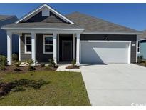 Charming single-story home featuring manicured lawn and a spacious two-car garage at 560 Duvall St., Longs, SC 29568