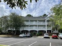Inviting condo with ample parking, neutral paint, white balconies and meticulous landscaping at 674 Riverwalk Dr. # 301, Myrtle Beach, SC 29579