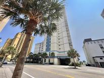 View of the resort exterior, tall building, blue sky and palm trees at 2504 N Ocean Blvd. # 734, Myrtle Beach, SC 29577