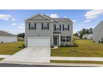 Charming two-story home featuring a two-car garage, and well-manicured lawn at 128 Caveson Way, Conway, SC 29526