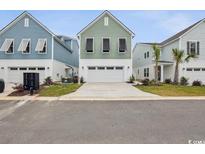 Charming exterior view of townhomes with vibrant colors and modern architectural details at 512 9Th Ave. S, North Myrtle Beach, SC 29582