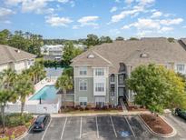 Condo building with pool and parking at 70 Addison Cottage Way # 216, Murrells Inlet, SC 29576