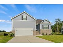 Charming two-story home with a brick-lined foundation, an attached garage, and a well-manicured front yard at 510 Antebellum Ln., Georgetown, SC 29440
