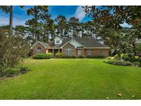 Charming single story brick home with dormer windows and a well-manicured lawn at 3517 Golf Ave., Little River, SC 29566
