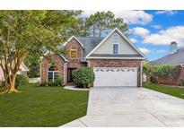 Charming brick home featuring an attached garage and a well-manicured front lawn at 2150 North Berwick Dr., Myrtle Beach, SC 29575