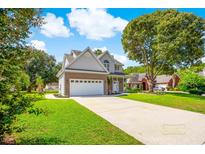 Charming two-story home featuring a brick and siding facade, a two-car garage, and a well-manicured lawn at 629 Slash Pine Ct., Myrtle Beach, SC 29579