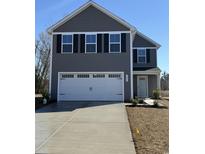 Charming two-story home with a gray exterior, black shutters, and a two-car garage with concrete driveway at 1055 Oak Meadow Dr., Conway, SC 29526