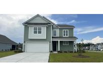 Charming two-story home with a two-car garage, manicured lawn, and attractive green siding at 748 Rupert Dr, Conway, SC 29526