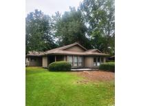 Charming single-story home surrounded by mature trees and lush landscaping at 931 Cedarwood Circle, Myrtle Beach, SC 29572