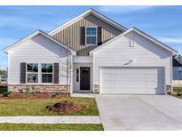 Two-story Craftsman style home with a two-car garage and a stone accent at 700 St. Albans Loop, Conway, SC 29526