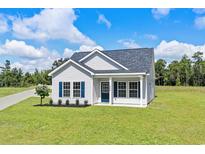 Charming single-story home featuring white siding, blue shutters, and a well-manicured lawn at 1174 St. John Rd., Galivants Ferry, SC 29544