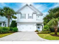 Charming two-story home with white siding, double garage, landscaped yard, and tropical palm trees at 4808 Cantor Ct., North Myrtle Beach, SC 29582