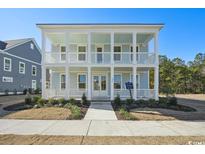 Two-story light blue house with white columns and porch at 1099 Milford Way, Myrtle Beach, SC 29588