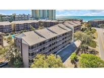 Scenic exterior view of a beachfront condo complex with stunning ocean views and lush landscaping at 212 2Nd Ave. N # 364, North Myrtle Beach, SC 29582