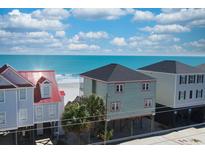 Coastal homes showcase vibrant exteriors and a beachfront view, perfect for seaside living at 328 S Waccamaw Dr., Garden City Beach, SC 29576